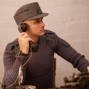Man wearing original British army pullover commando jumper in blue grey wool using vintage telephone