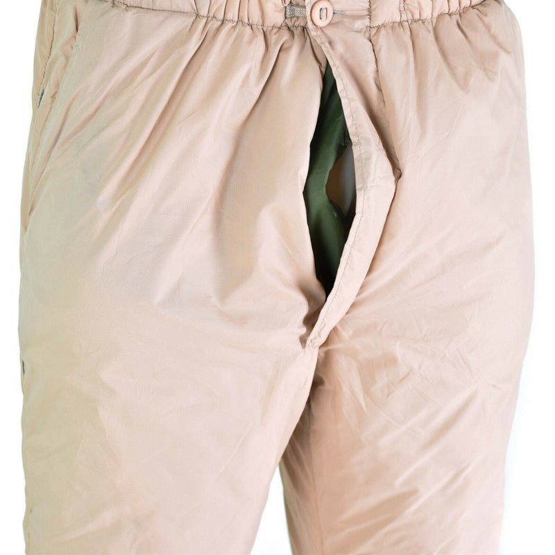 Close-up of British army reversible thermal pants showing khaki outer layer and green inner lining for cold weather use