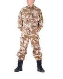 Man wearing genuine British army desert camouflage combat trousers and jacket with black military boots