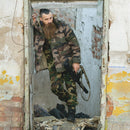 Man wearing genuine French army CCE camo waterproof trilaminate jacket and pants in an abandoned building doorway