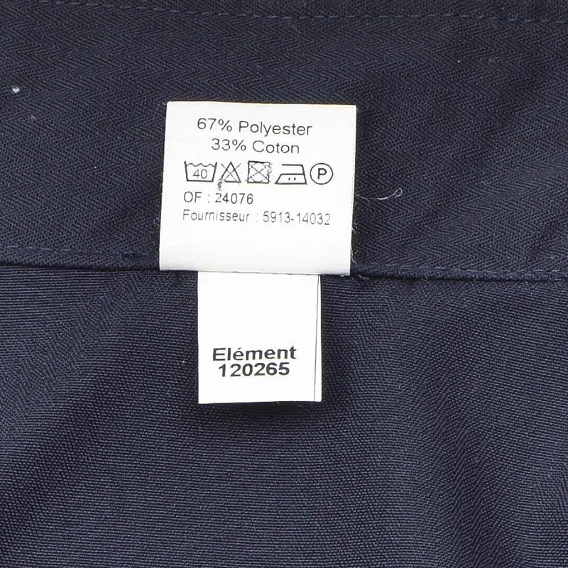Close-up of fabric label showing 67% polyester 33% cotton content on navy blue military police jacket