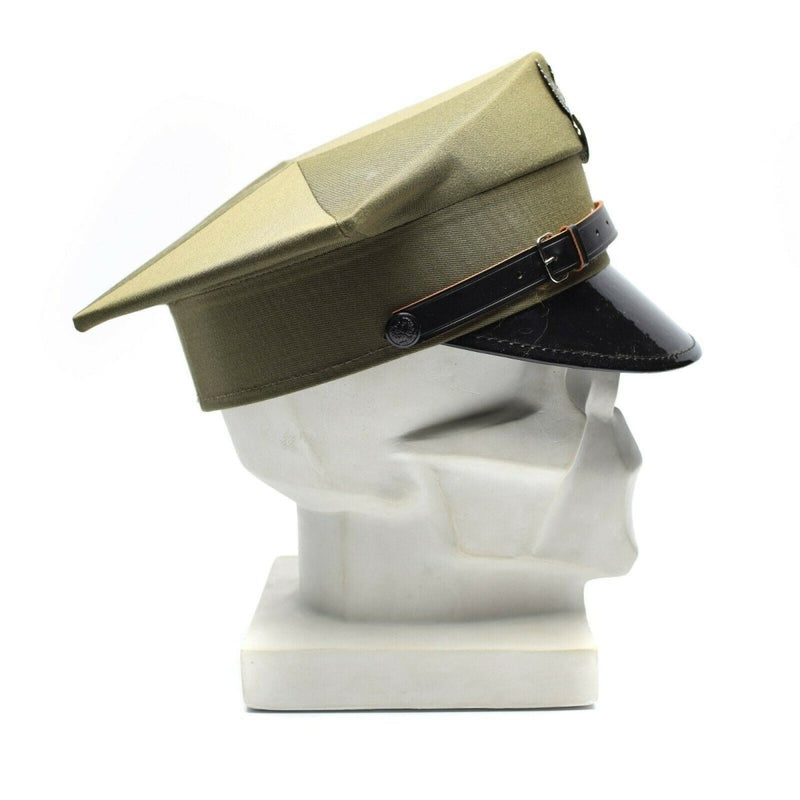 Vintage Polish military officer peaked cap in olive green with black visor and adjustable chinstrap on a mannequin head
