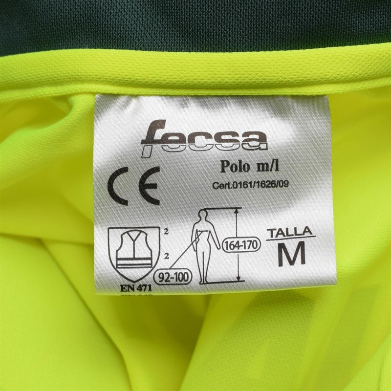 Close-up of size M label on yellow high-visibility Genuine Spanish long sleeve polo shirt for civil guard safety wear