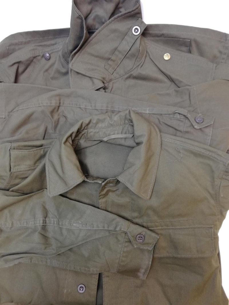 Vintage Czech army M85 field jacket in olive green with button closures and multiple pockets displayed flat.