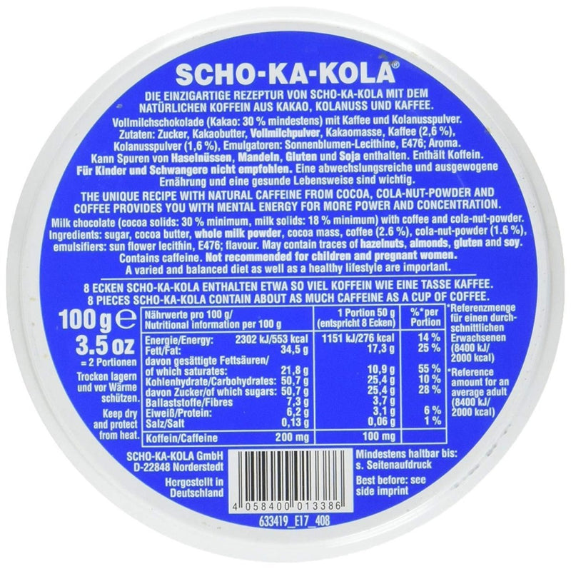 Round blue tin can of Scho-Ka-Kola German milk chocolate with caffeine, 100g, showing ingredient and nutrition labels.