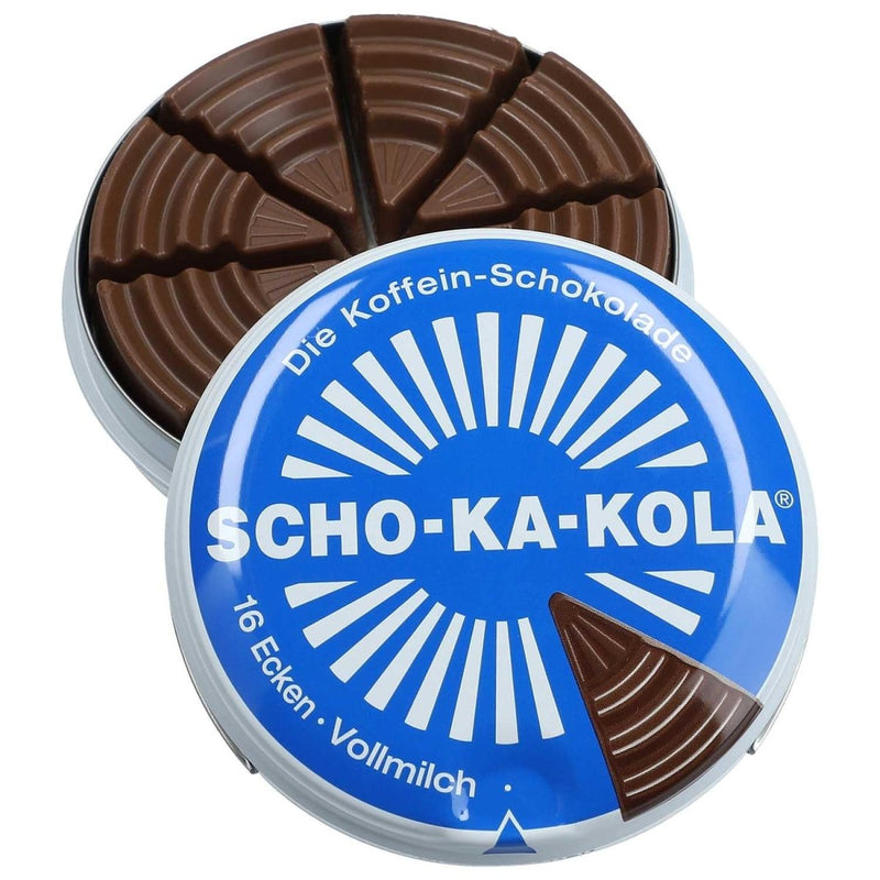 Round blue tin of German Scho-Ka-Kola milk chocolate with caffeine, segmented into wedge-shaped pieces.