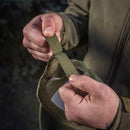 Hands adjusting the olive green M-TAC tactical baseball cap's durable hook and loop strap for a custom fit outdoors.