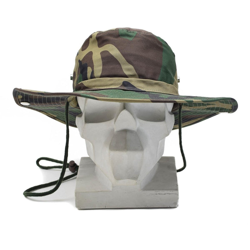 Woodland camouflage boonie hat with wide brim and adjustable chin strap on a white mannequin head