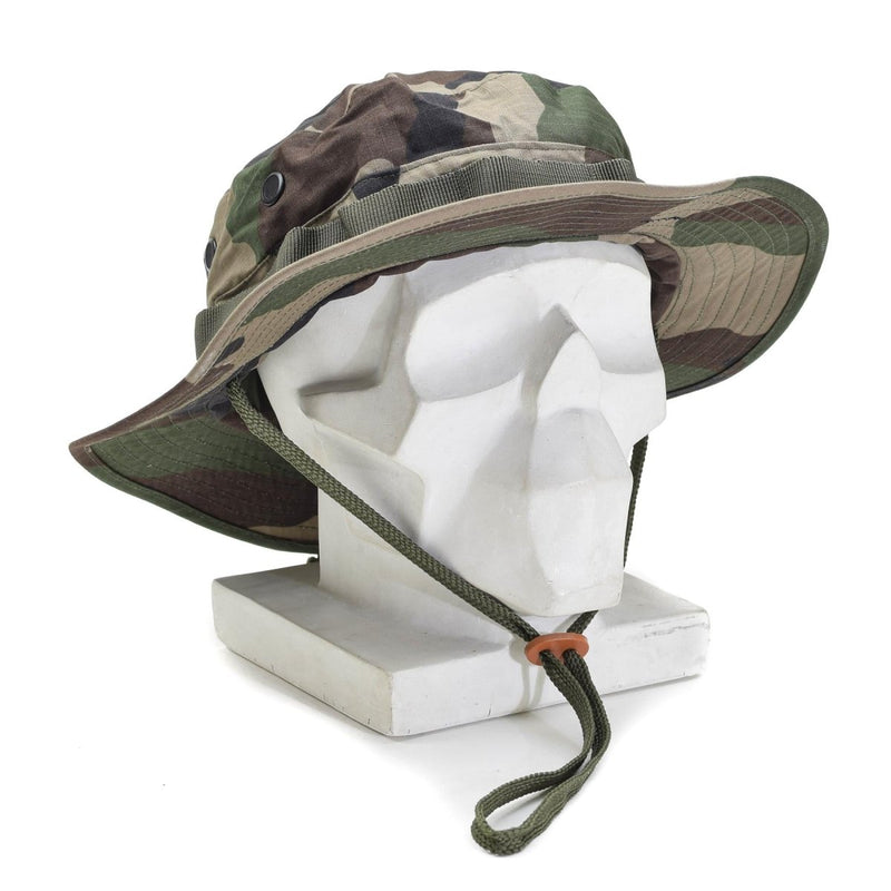 Mil-Tec lightweight military boonie hat with CCE camo, foldable brim, ripstop fabric, and adjustable chinstrap on display stand.