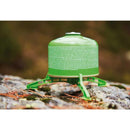 Green gas canister securely supported on a lightweight, durable outdoor foot stand on rocky ground