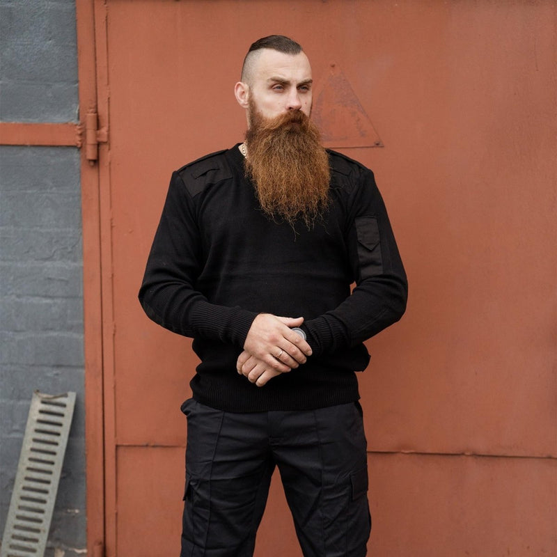 Man wearing black original British army police commando pullover with reinforced elbows and shoulders
