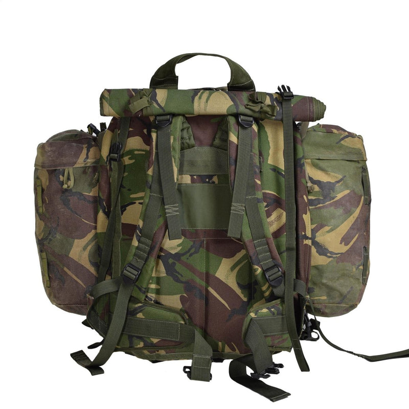 Original British military tactical backpack in DPM camouflage with padded straps and modular side pouches for hiking and camping.