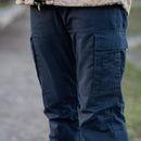 Close-up of navy blue original Dutch military work pants with reinforced knees and cargo pockets for durability and storage