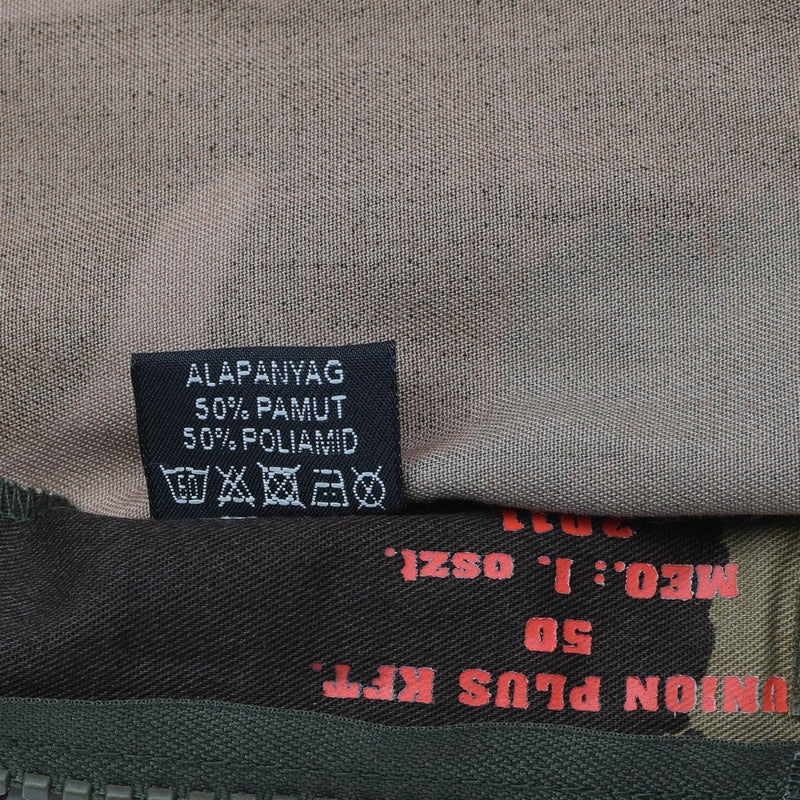 Close-up of a fabric label showing material composition 50% cotton and 50% polyamide in a Hungarian army M1990 field jacket