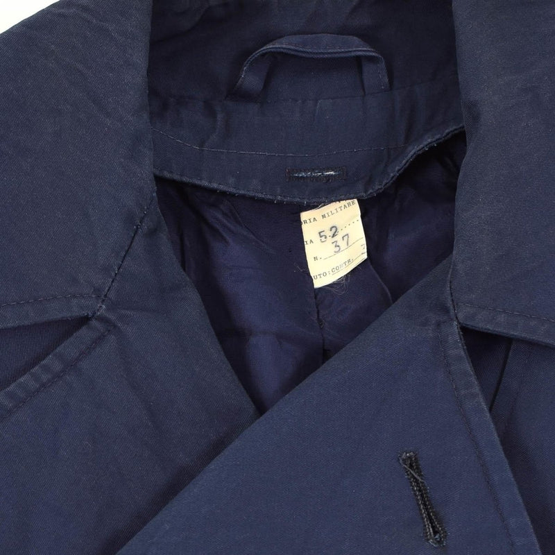 Close-up of vintage original Italian military trenchcoat in khaki blue waterproof raincoat fabric showing collar and label.