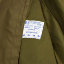 Close-up of original vintage Italian army trenchcoat label with care instructions inside khaki raincoat