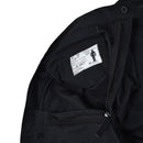 Close-up of inside black Swedish Army M90 thermal pants showing label, zipper, and button details.