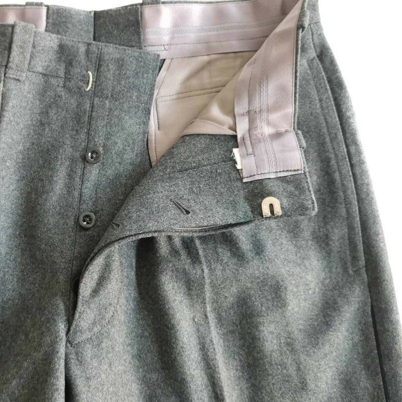 Gray pants with a close-up of a pocket on a white background