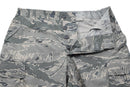 Close-up of original U.S. military digital tiger stripe camo field pants with button fly and cargo pockets.