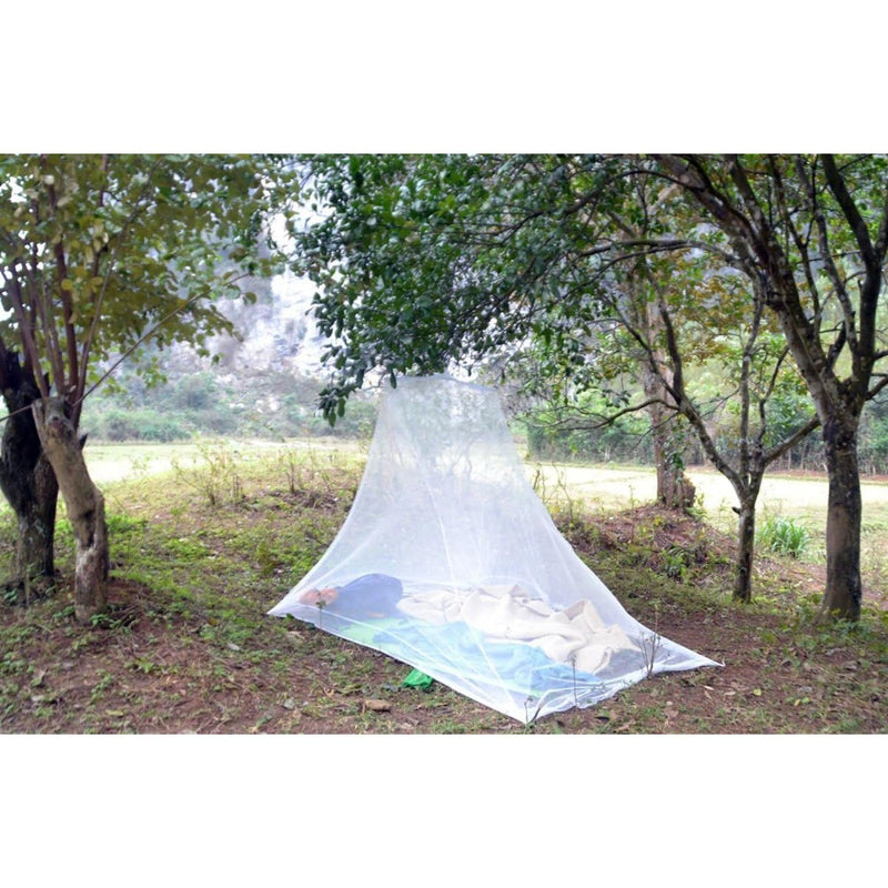 Mosquito net over a sleeping bag in a forest setting