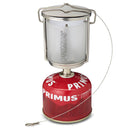 Primus Mimer portable camping lantern with stainless steel body and frosted glass on red gas fuel canister.