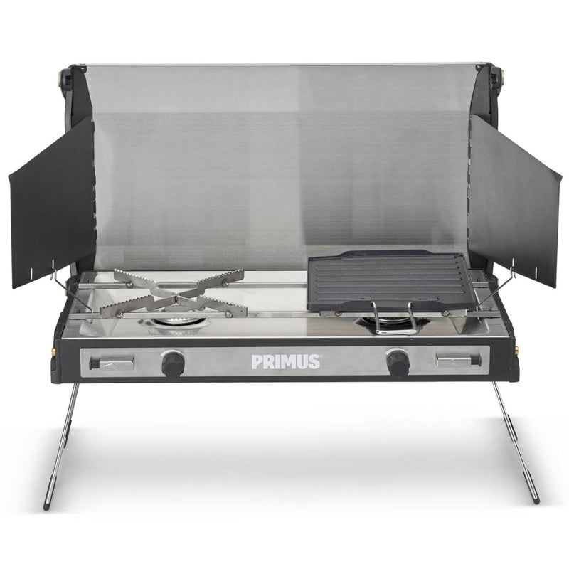 Primus Tupike dual gas burner outdoor stove with foldable legs and removable griddle for camping cooking.